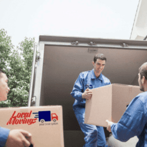 Three men loading boxes into a moving truck.