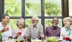 A group of older people enjoying a meal together.