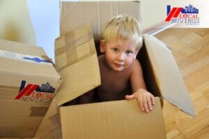 Toddler sitting inside carton box