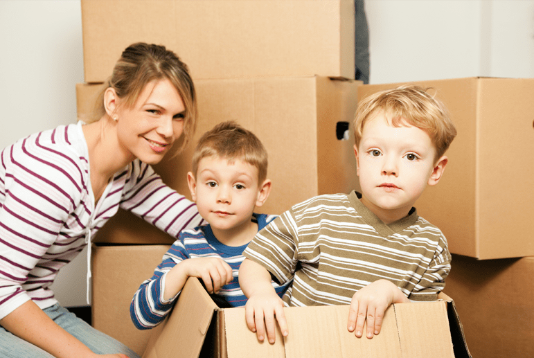 A woman and two children in a moving box.